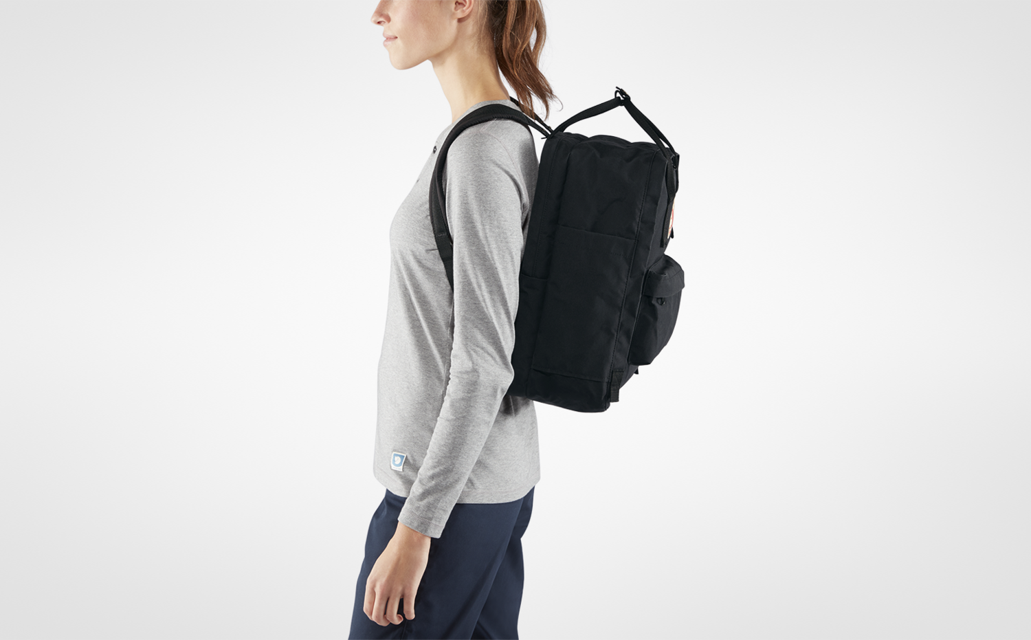 a girl wearing kanken laptop backpack
