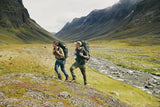 two men wearing Fjällräven products are trekking