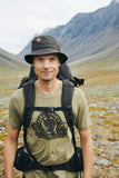 man wearing branded cloths of fjallraven with a backpack on his back.