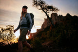 one women is trekking at the time of sun set with wearing fjallraven products