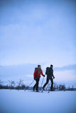 A couple wearing trekking clothes is trekking in the ice 
