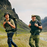 two men wearing Fjällräven products are trekking